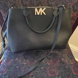 Lightly used Michael Kors MK purse.  Black with gold zippers.  3 compartments.